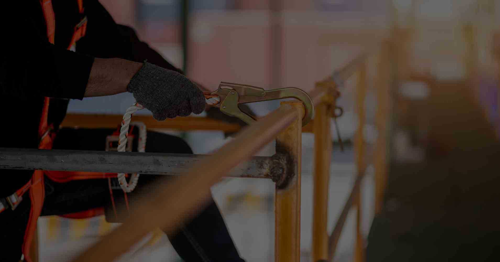 man attaching a safety clip to a railing