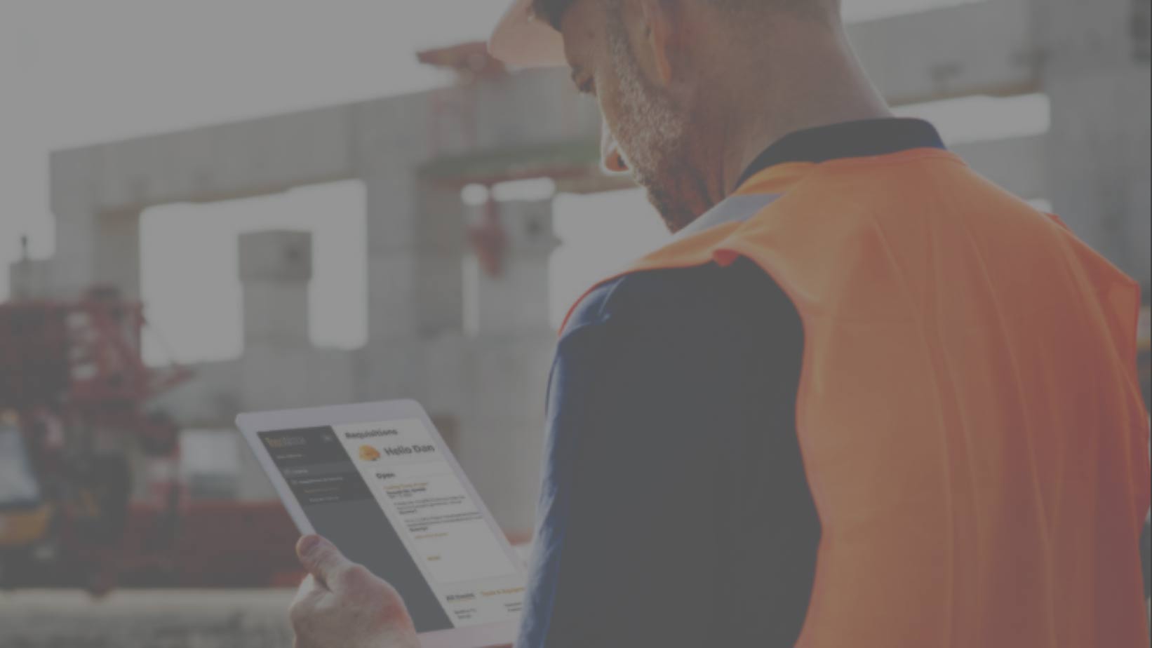 construction worker looking at iPad