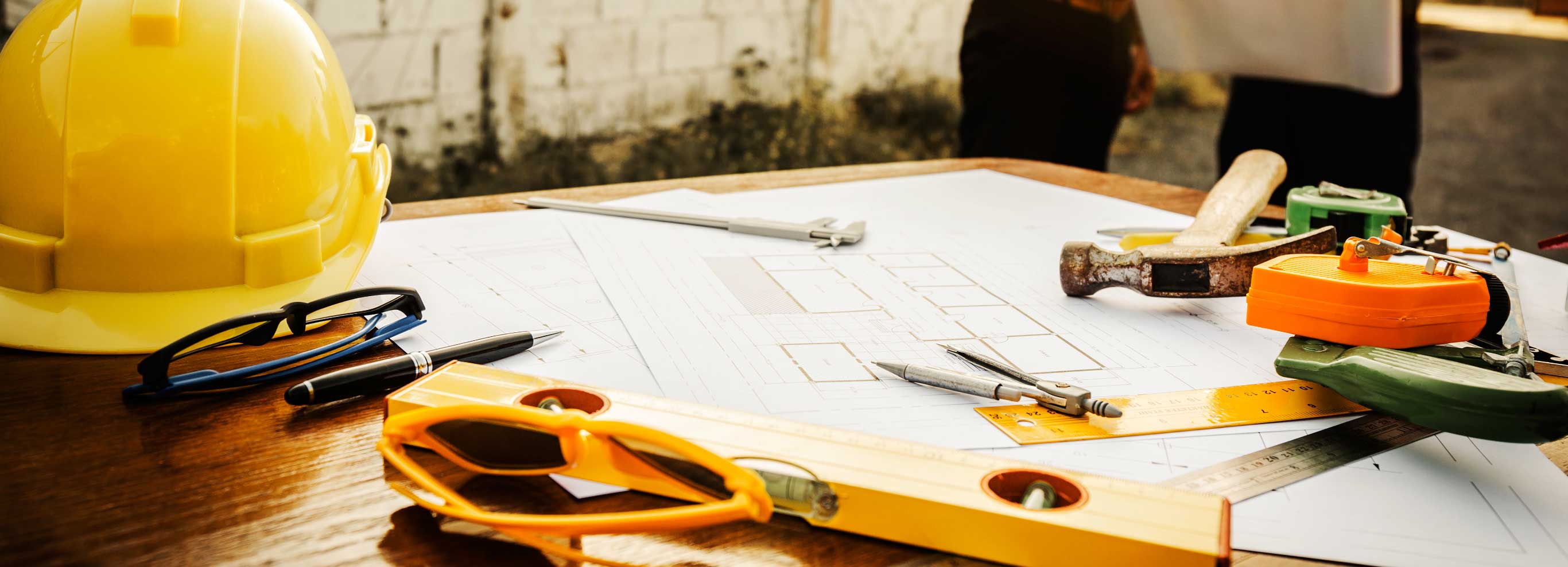 hard hat and building plans with tools