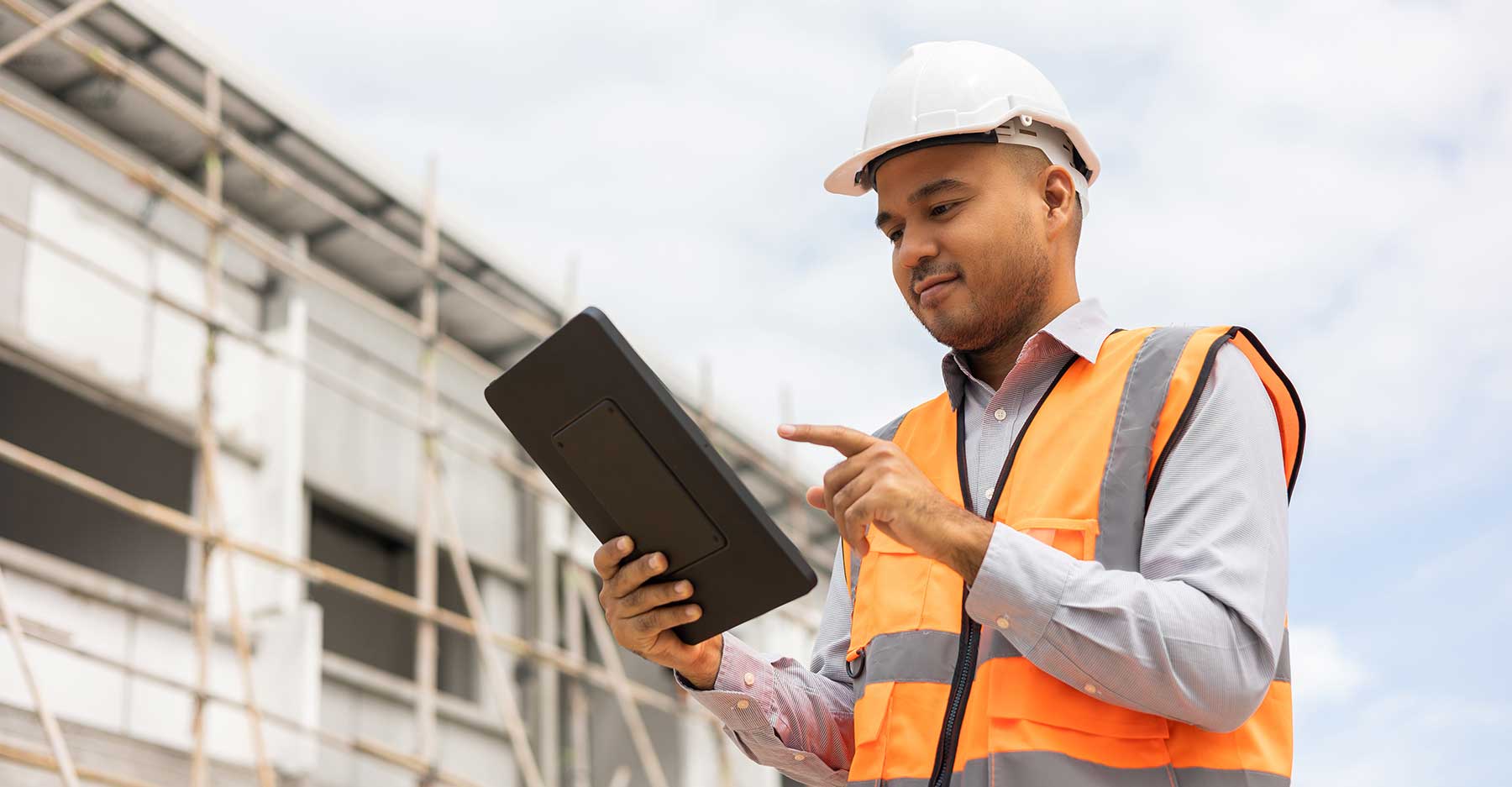 man using tablet at job site